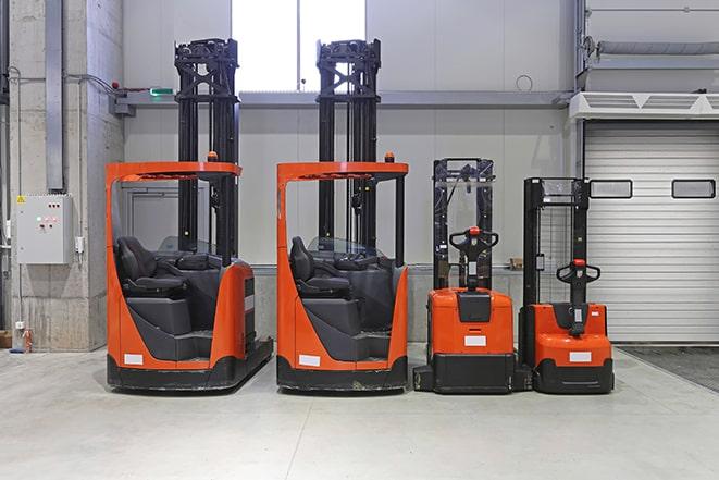 forklift operators maneuvering through a busy work area